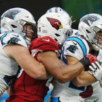 Carolina Panthers running back Christian McCaffrey is tackled by Arizona Cardinals linebacker Zaven Collins during the first half of an NFL football game on Sunday, Oct. 2, 2022, in Charlotte, N.C. (AP Photo/Rusty Jones)
