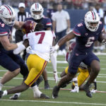 
              Arizona running back Michael Wiley (6) runs the ball by Southern California defensive back Calen Bullock (7) in the first half during an NCAA college football game, Saturday, Oct. 29, 2022, in Tucson, Ariz. (AP Photo/Rick Scuteri)
            
