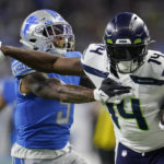 
              Seattle Seahawks wide receiver DK Metcalf (14) pushes Detroit Lions safety DeShon Elliott (5) during the first half of an NFL football game, Sunday, Oct. 2, 2022, in Detroit. (AP Photo/Paul Sancya)
            