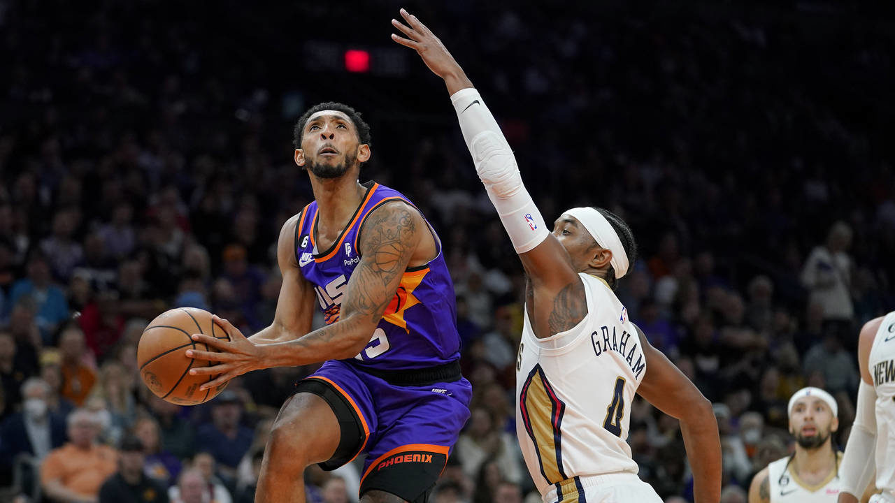 Phoenix Suns guard Cameron Payne shoots as New Orleans Pelicans guard Devonte' Graham (4) defends d...