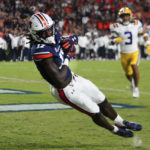Auburn wide receiver Camden Brown (17) makes a catch for a touchdown as LSU safety Greg Brooks Jr. (3) defends in the first half of an NCAA college football game, Saturday, Oct. 1, 2022, in Auburn, Ala. (AP Photo/John Bazemore)