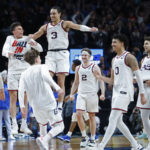 
              FILE - Gonzaga guard Andrew Nembhard (3) and forward Drew Timme (2) react with teammates after they beat Memphis 82-78 in a second-round NCAA college basketball tournament game, Saturday, March 19, 2022, in Portland, Ore. Gonzaga, the preseason No. 1 the previous two years, is No. 2 in the preseason AP Top 25 men's basketball poll released Monday, Oct. 17, 2022. (AP Photo/Craig Mitchelldyer, File)
            