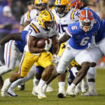
              LSU running back Josh Williams (27) gains yardage as he gets past Florida linebacker Shemar James (6) during the first half of an NCAA college football game, Saturday, Oct. 15, 2022, in Gainesville, Fla. (AP Photo/John Raoux)
            