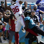 New York Giants wide receiver Darius Slayton (86) pulls in a touchdown reception over Jacksonville Jaguars cornerback Tre Herndon (37) during the first half of an NFL football game Sunday, Oct. 23, 2022, in Jacksonville, Fla. (AP Photo/John Raoux)