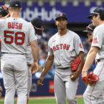 
              Boston Red Sox starting pitcher Brayan Bellos visited at the mound by teammates during the second inning of a baseball game against the Toronto Blue Jays in Toronto on Saturday, Oct. 1, 2022. (Christopher Katsarov/The Canadian Press via AP)
            