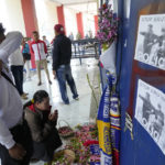 
              A man breaks down at a memorial for the victims of Saturday's soccer match stampede in front of gate 13 at the Kanjuruhan Stadium in Malang, Indonesia, Tuesday, Oct 4, 2022. A police chief and nine elite officers were removed from their posts Monday and 18 others were being investigated for responsibility in the firing of tear gas inside a soccer stadium that set off a stampede, killing over 100 people, officials said. (AP Photo/Achmad Ibrahim)
            