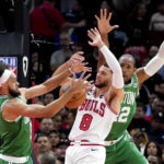 
              Boston Celtics' Derrick White (9) and Al Horford pressure Chicago Bulls' Zach LaVine during the first half of an NBA basketball game Monday, Oct. 24, 2022, in Chicago. (AP Photo/Charles Rex Arbogast)
            