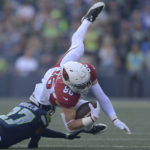 Arizona Cardinals tight end Zach Ertz (86) is tackled by Seattle Seahawks cornerback Tariq Woolen (27) during the second half of an NFL football game in Seattle, Sunday, Oct. 16, 2022. (AP Photo/Caean Couto)