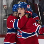 Montreal Canadiens' Juraj Slafkovsky celebrates his goal against the Arizona Coyotes with Jake Evans during the second period of an NHL hockey game in Montreal, Thursday, Oct. 20, 2022. (Paul Chiasson/The Canadian Press via AP)