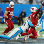 Arizona Cardinals quarterback Kyler Murray passes under pressure from Carolina Panthers defensive end Brian Burns during the second half of an NFL football game on Sunday, Oct. 2, 2022, in Charlotte, N.C. (AP Photo/Rusty Jones)