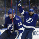 
              Tampa Bay Lightning right wing Corey Perry (10) celebrates after scoring against the New York Islanders during the second period of an NHL hockey game Saturday, Oct. 22, 2022, in Tampa, Fla. Also celebrating is left wing Pat Maroon (14). (AP Photo/Chris O'Meara)
            