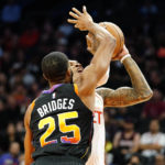 Houston Rockets' Kevin Porter Jr., right, is fouled by Phoenix Suns' Mikal Bridges (25) during the first half of an NBA basketball game, Sunday, Oct. 30, 2022, in Phoenix. (AP Photo/Darryl Webb)