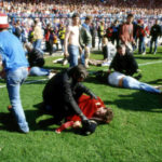 
              FILE - Stewards and supporters tend and care for wounded supporters on the field at Hillsborough Stadium, in Sheffield, England, April 15, 1989. (AP Photo, File)
            