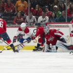 
              Montreal Canadiens center Nick Suzuki (14) scores a wraparound goal against Washington Capitals goaltender Darcy Kuemper (35) while being defended by Nic Dowd (26), defenseman Nick Jensen (3), Conor Sheary during the second period of an NHL hockey game, Saturday, Oct. 15, 2022, in Washington. (AP Photo/Jess Rapfogel)
            