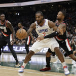 
              Los Angeles Clippers' Kawhi Leonard (2) draws a foul from Portland Trail Blazers' Damian Lillard, behind,  during the first half of a preseason NBA basketball game, Monday, Oct. 3, 2022, in Seattle. (AP Photo/ John Froschauer)
            