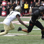 Louisville wide receiver Jaelin Carter tries to avoid the tackle attempt by Wake Forest defensive back Caelen Carson during the first half of an NCAA college football game in Louisville, Ky., Saturday, Oct. 29, 2022. (AP Photo/Timothy D. Easley)