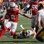 
              Ohio State receiver Emeka Egbuka, left, runs after catching a pass against Iowa during the first half of an NCAA college football game Saturday, Oct. 22, 2022, in Columbus, Ohio. (AP Photo/Jay LaPrete)
            
