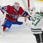 
              Montreal Canadiens goaltender Jake Allen (34) makes a glove-save onagainst Dallas Stars left wing Mason Marchment (27) during first-period NHL hockey game action Saturday, Oct. 22, 2022, in Montreal. (Ryan Remiorz/The Canadian Press via AP)
            