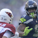 Seattle Seahawks running back Kenneth Walker III (9) runs for a touchdown against Arizona Cardinals cornerback Byron Murphy Jr. (7) during the second half of an NFL football game in Seattle, Sunday, Oct. 16, 2022. (AP Photo/Caean Couto)