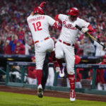 Philadelphia Phillies' Kyle Schwarber celebrates his home run with Rhys Hoskins during the sixth inning in Game 4 of the baseball NL Championship Series between the San Diego Padres and the Philadelphia Phillies on Saturday, Oct. 22, 2022, in Philadelphia. (AP Photo/Matt Slocum)