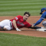 
              Cleveland Guardians' Will Brennan, left, slides safely into third base under the tag of Kansas City Royals' Nate Eaton during the first inning of a baseball game in Cleveland, Sunday, Oct. 2, 2022. (AP Photo/Phil Long)
            