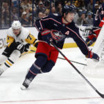 
              Columbus Blue Jackets defenseman Zach Werenski, right, controls the puck in front of Pittsburgh Penguins forward Evgeni Malkin during the first period of an NHL hockey game in Columbus, Ohio, Saturday, Oct. 22, 2022. (AP Photo/Paul Vernon)
            