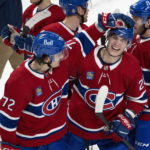 Montreal Canadiens' Juraj Slafkovsky, front right, and teammate Arber Xhekaj celebrate their victory over the Arizona Coyotes in NHL hockey game action in Montreal, Thursday, Oct. 20, 2022. (Paul Chiasson/The Canadian Press via AP)