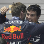 
              Red Bull driver Sergio Perez, right, of Mexico is congratulated by teammate Max Verstappen of the Netherlands after winning the Singapore Formula One Grand Prix, at the Marina Bay City Circuit in Singapore, Sunday, Oct.2, 2022. (AP Photo/Vincent Thian )
            