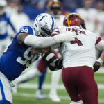 Indianapolis Colts defensive tackle DeForest Buckner (99) sacks Washington Commanders quarterback Taylor Heinicke (4) in the first half of an NFL football game in Indianapolis, Sunday, Oct. 30, 2022. (AP Photo/Darron Cummings)