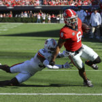 
              Georgia running back Kenny McIntosh gets in the end zone past Auburn cornerback Jaylin Simpson during the first half of an during an NCAA college football game, Saturday, Oct. 8, 2022, in Athens, Ga. (Curtis Compton/Atlanta Journal-Constitution via AP)
            