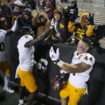From left, Arizona State wide receiver Charles Hall IV, defensive back Chris Edmonds and fullback Case Hatch celebrate with fans after an NCAA college football game against Colorado, Saturday, Oct. 29, 2022, in Boulder, Colo. (AP Photo/David Zalubowski)