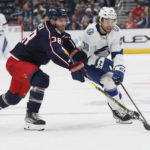 Columbus Blue Jackets' Boone Jenner, left, and Brandon Hagel chase the puck during the third period of an NHL hockey game Friday, Oct. 14, 2022, in Columbus, Ohio. (AP Photo/Jay LaPrete)