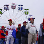 Fans arrive Game 3 of baseball's World Series between the Houston Astros and the Philadelphia Phillies on Monday, Oct. 31, 2022, in Philadelphia. The game was postponed by rain Monday night with the matchup tied 1-1. (AP Photo/Matt Rourke)