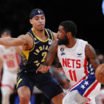 
              Brooklyn Nets guard Kyrie Irving (11) drives to the basket against Indiana Pacers guard Andrew Nembhard (2) during the first half of an NBA basketball game, Saturday, Oct. 29, 2022, in New York. (AP Photo/Noah K. Murray)
            