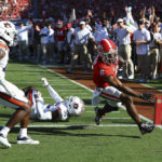 
              Georgia running back Kenny McIntosh gets in the end zone past Auburn cornerback Jaylin Simpson (36) during the first half of an during an NCAA college football game, Saturday, Oct. 8, 2022, in Athens, Ga. (Curtis Compton/Atlanta Journal-Constitution via AP)
            