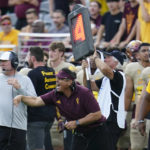 Arizona State interim head coach Shaun Aguano, center, shouts at officials during the second half of an NCAA college football game against Washington in Tempe, Ariz., Saturday, Oct. 8, 2022. (AP Photo/Ross D. Franklin)