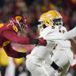 Arizona State quarterback Emory Jones, right, breaks away from an attempted sack by Southern California defensive lineman Nick Figueroa during the first half of an NCAA college football game Saturday, Oct. 1, 2022, in Los Angeles. (AP Photo/Mark J. Terrill)
