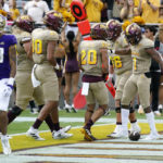 Arizona State's running back Xazavian Valladay (1) celebrates after his touchdown run with wide receiver Giovanni Sanders (20), offensive lineman Ben Scott (66), tight end Messiah Swinson (80) and offensive lineman Emmit Bohle (70) as Washington linebacker Kamren Fabiculanan (13) walks back to the sideline during the first half of an NCAA college football game in Tempe, Ariz., Saturday, Oct. 8, 2022. (AP Photo/Ross D. Franklin)