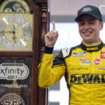 
              Christopher Bell (20) poses with the trophy in Victory Lane after winning a NASCAR Cup Series auto race at Martinsville Speedway, Sunday, Oct. 30, 2022, in Martinsville, Va. (AP Photo/Chuck Burton)
            