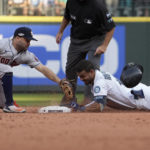 Seattle Mariners' Julio Rodriguez (44) slides safely into second base for a double under Houston Astros second baseman Jose Altuve during the eighth inning in Game 3 of an American League Division Series baseball game Saturday, Oct. 15, 2022, in Seattle. (AP Photo/Ted S. Warren)