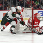 
              Detroit Red Wings goaltender Ville Husso, right, blocks the shot of Minnesota Wild's Brandon Duhaime during the first period of an NHL hockey game, Saturday, Oct. 29, 2022, in Detroit. (AP Photo/Jose Juarez)
            