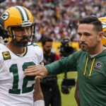 Green Bay Packers quarterback Aaron Rodgers (12) and head coach Matt LaFleur react during the second half of an NFL football game against the Washington Commanders, Sunday, Oct. 23, 2022, in Landover, Md. (AP Photo/Al Drago)