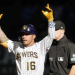 
              Milwaukee Brewers' Kolten Wong gestures after hitting an RBI-double during the ninth inning of a baseball game against the Miami Marlins, Sunday, Oct. 2, 2022, in Milwaukee. (AP Photo/Aaron Gash)
            