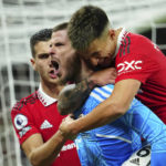 
              Manchester United's goalkeeper David de Gea, centre, celebrates with his teammates Manchester United's Lisandro Martinez, right, and Manchester United's Diogo Dalot during the English Premier League soccer match between Manchester United and West Ham United at Old Trafford stadium in Manchester, England, Sunday, Oct. 30, 2022. (AP Photo/Jon Super)
            