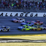 
              Chase Elliott (9) leads the field to the finish line during a NASCAR Cup Series auto race Sunday, Oct. 2, 2022, in Talladega, Ala. (AP Photo/Butch Dill)
            