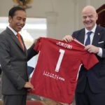 
              Indonesian President Joko Widodo, left, who is popularly known as 'Jokowi' receives a gift of a soccer jersey with his name on it, from FIFA President Gianni Infantino during their meeting at Merdeka Palace in Jakarta, Indonesia, Tuesday, Oct. 18, 2022. (AP Photo/Achmad Ibrahim)
            