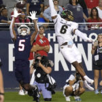 Arizona wide receiver Dorian Singer (5) catches a touchdown pass next to Colorado cornerback Nikko Reed during the first half of an NCAA college football game Saturday, Oct. 1, 2022, in Tucson, Ariz. (AP Photo/Rick Scuteri)