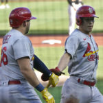 St. Louis Cardinals' Tommy Edman, right, is greeted by Juan Yepez. Left, after scoring on an error on a ground ball by Corey Dickerson during the first inning of a baseball game against the Pittsburgh Pirates, Wednesday, Oct. 5, 2022, in Pittsburgh. (AP Photo/Keith Srakocic)