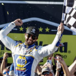 
              Chase Elliott celebrates in Victory Lane after winning a NASCAR Cup Series auto race, Sunday, Oct. 2, 2022, in Talladega, Ala. (AP Photo/Butch Dill)
            