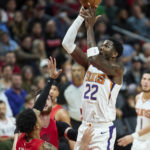 Phoenix Suns center Deandre Ayton, right, shoots over Portland Trail Blazers guard Anfernee Simons during the second half of an NBA basketball game in Portland, Ore., Friday, Oct. 21, 2022. (AP Photo/Craig Mitchelldyer)